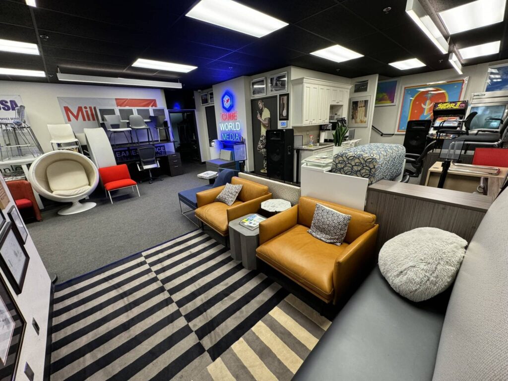 Modern office furniture display with chairs, desks, and decor at Cube World USA.