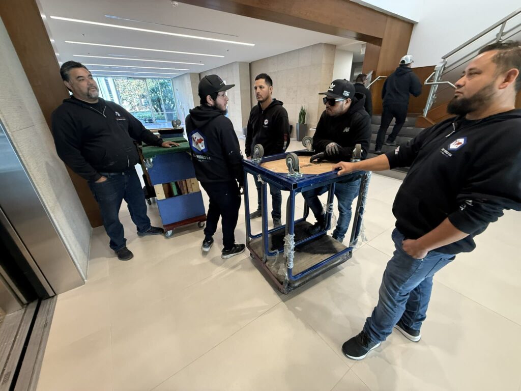 Professional installation team setting up equipment indoors.
