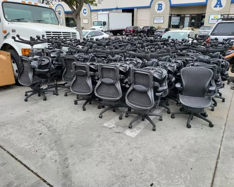 Office chairs and desks for liquidation sale at Cube World USA.