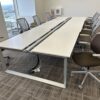 Modern office conference room with ergonomic chairs and adjustable tables.