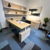 Office workspace with contemporary furniture and artwork for professional environments.