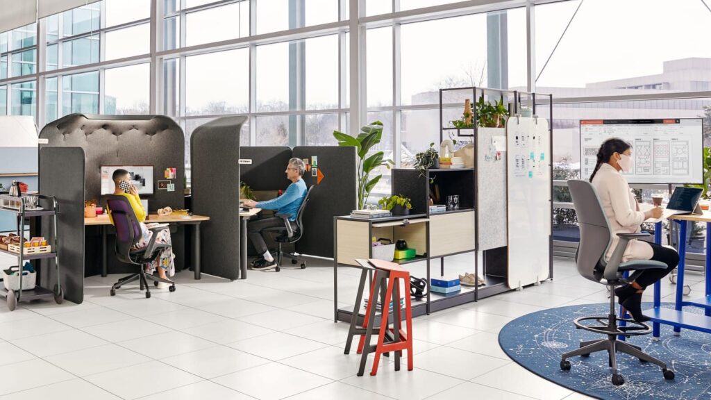 Office workspace with privacy pods and ergonomic chairs for focused work.