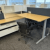 Modern office cubicle workspace with desk and chair setup.