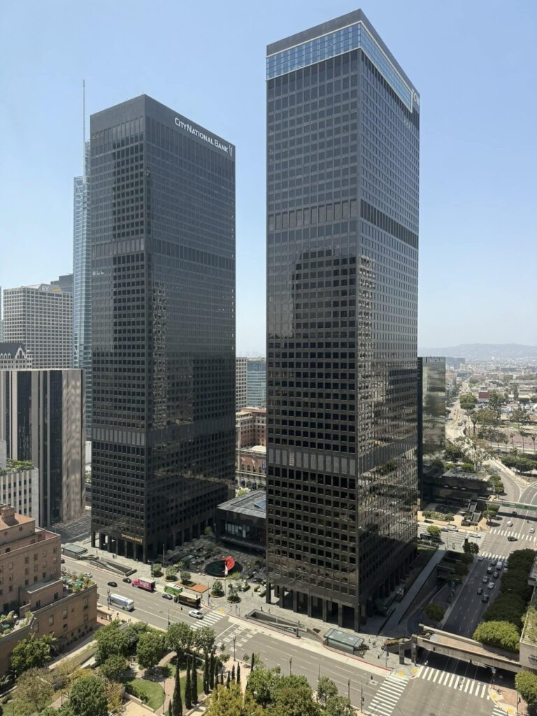 Rise buildings with glass facades in a cityscape.