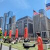NeoCon 2024 cityscape with outdoor seating and American flags in Chicago.