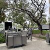 Pre-owned office cubicles and furniture being arranged outdoors for liquidation sale.