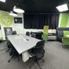 Modern office furniture setup with chairs, tables, and lounge areas.