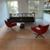 Stylish office lounge with modern seating and large windows for natural light.