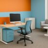 Contemporary office with desk, chair, and lounge area for professional work environments.